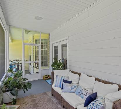 The screened porch with seating for everyone is your go-to for laid-back meals, cozy hang outs, and evening breezes without the bugs.