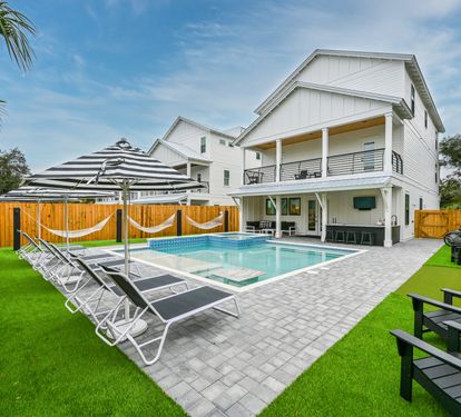 Satisfying Astroturf with luxury lounges, matching umbrellas, poolside hammocks, and putting green.