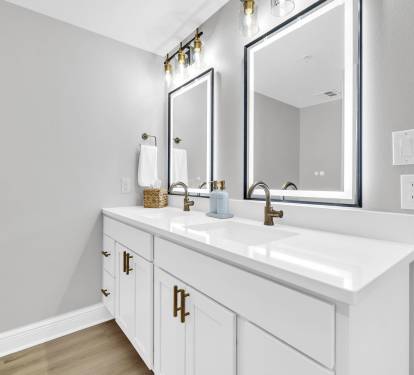 A bright double vanity featuring LED lighted, steam-free mirrors, modern finishes, and plenty of space to get ready with ease.