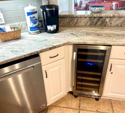 Kitchen is equipped with a wine fridge 