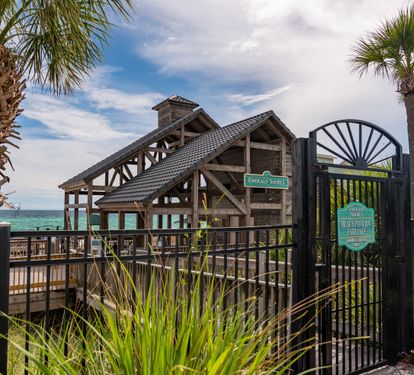 Beach pavilion and gated walkway to the Gulf