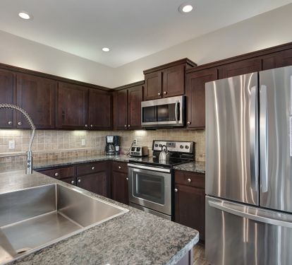Modern kitchen with stainless-steel appliances and granite countertops