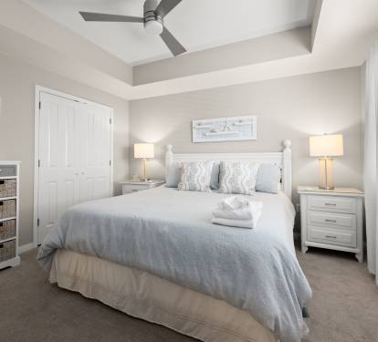 King-size bed dressed in crisp linens for a comfortable sleep.