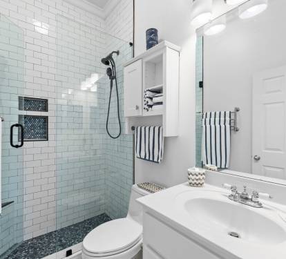 The second bathroom has been freshly remodeled with a large tiled walk-in shower