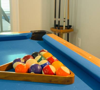 A full billiards setup creates the perfect spot to unwind, challenge friends, and keep the vacation fun going indoors.