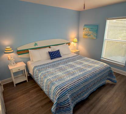 Second Floor Bedroom 3 brings a bright coastal feel with soft ocean-blue tones, beach-inspired décor, and a cozy space designed for restful nights.