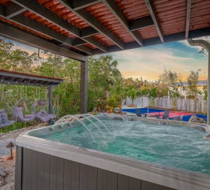 Indulge in the luxurious experience of our private hot tub, nestled beneath a shaded pergola. It's the ideal setting for ultimate relaxation and serenity.