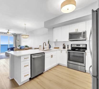 A fully updated kitchen featuring stainless steel appliances, including a full-size refrigerator, oven, microwave, and dishwasher—everything you need for easy, stress-free meals during your stay.