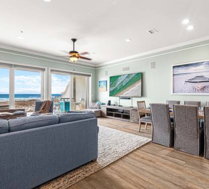 Living room area with beautiful ocean views and 85" TV perfect for movie nights and watching your favorite sports teams!