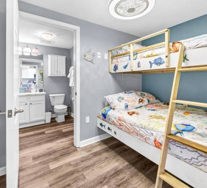 Bunk room angle showing easy access to the nearby bathroom & hallway