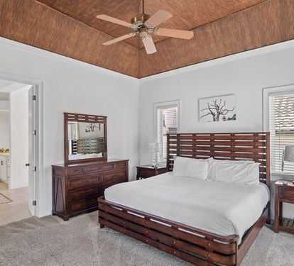 Primary suite featuring bamboo ceilings and custom tray lighting
