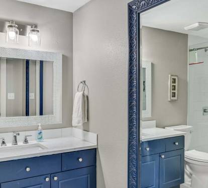 Private Ensuite Convenience - The primary bath
features sleek finishes, a spacious vanity, and walkin
shower with glass doors