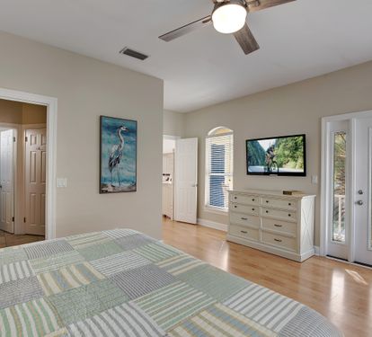 King bedroom with ensuite bath and balcony doors
