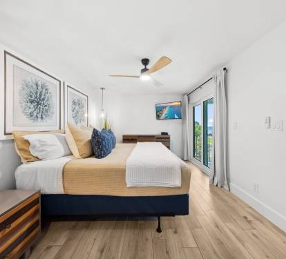 Primary suite with comfortable king mattress, TV and view of the Gulf of Mexico