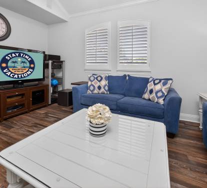 Inviting living room w/ comfy seating, wood floors, and a cozy setup for movie nights.