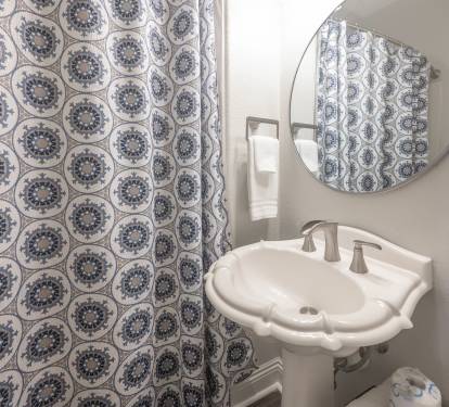Patterned shower curtain adding visual interest to the bathroom.
