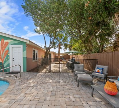 Step outside and take it all in. The full backyard gives you pool on one side, hammock lounge on the other, and a mural backdrop that
guests photograph every single stay.