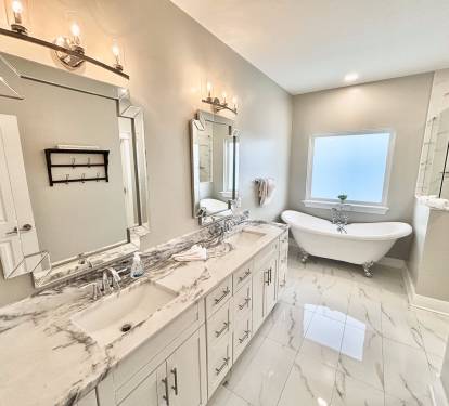 Master bathroom with double vanity and tub