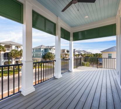Covered upper front porch just off the upstairs master and hallway beverage station with coffee, tea, and a mini fridge for cold drinks—no need to head downstairs. Adirondack seating, classic haint blue ceiling, and peaceful neighborhood views create a re