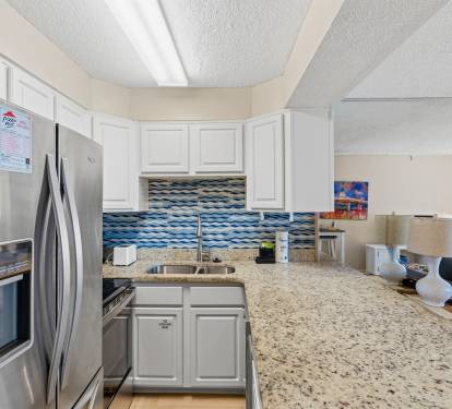 This beautifully updated kitchen offers coastal charm with modern convenience and style. 