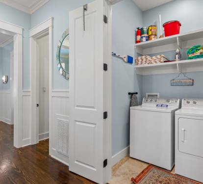 Hallway laundry nook w/ washer, dryer & open shelving to keep stays easy and organized.