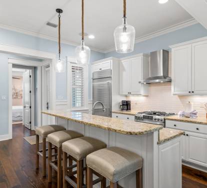 Bright kitchen w/ granite island, bar seating & pendant lights—great for cooking and gathering.