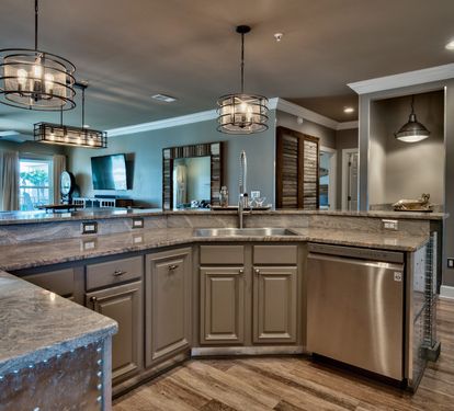 Kitchen with NOLA faucet, zero radius sink and stainless appliances.