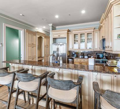 Fully stocked kitchen with island bar and barstools for socializing while prepping your favorite meal!