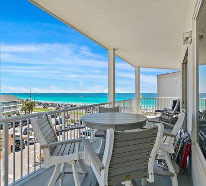 Balcony seating overlooking the sugar-white sand