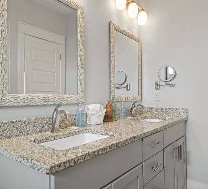 Grand Master ensuite vanity with granite countertop and upgraded lighting.