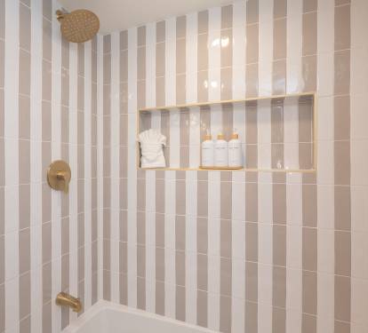 Beautifully tiled tub/shower with shampoo, conditioner & body wash provided.