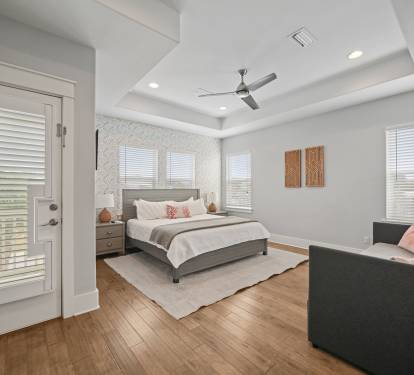 Light-filled Grand Master King Suite offering a spacious layout and private ensuite bath, large walk in closet, and private outdoor balcony.