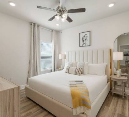 Bedroom 4: MIL Bedroom A relaxing retreat with windows for natural light, a ceiling fan, and bedside lamps.
