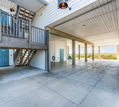 Exterior Stairs and Elevator for Easy Access. Spacious Area Beneath the House can be used for Covered Parking or Special Events