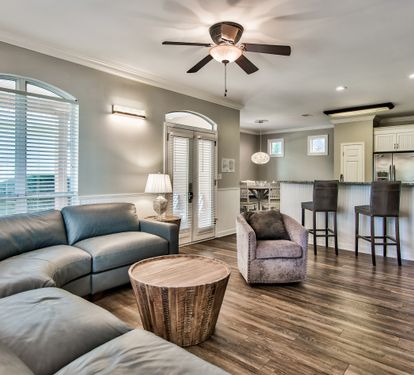Open-concept living area with vaulted ceilings and abundant natural light