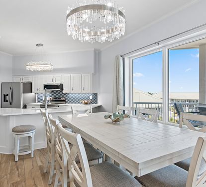 Gulf-view dining area with elegant crystal chandelier