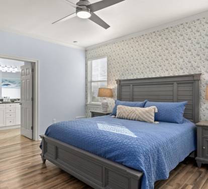 A king-bed retreat with sailboat wallpaper and an ensuite bath just steps away.