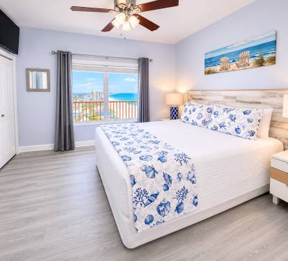 Beach-view king-suite bedroom with an en-suite.  Features a ceiling fan and a Roku TV 