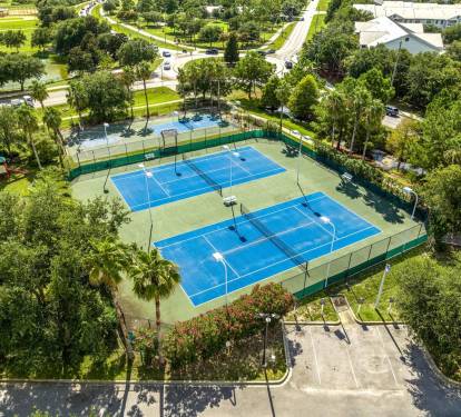 On-site tennis courts surrounded by greenery, great for staying active during your stay