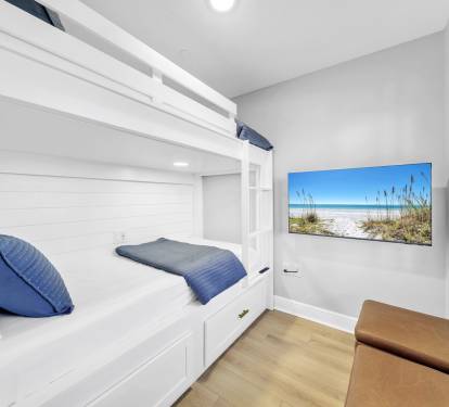 Built-in bunks with outlets, reading lights, and storage drawers underneath for clothes make this space both fun and functional. 