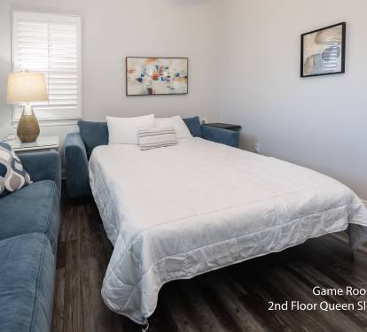 Comfortable bedroom styled w/ simple art and cozy textures