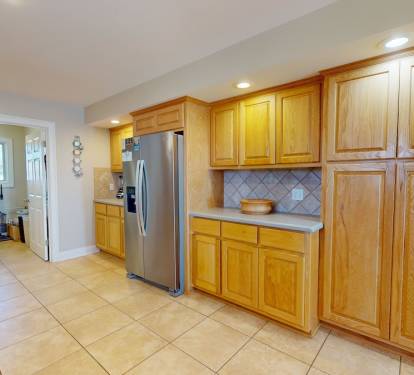 Kitchen with side by side refrigerator