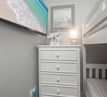Bunk room with storage and flat screen for the kiddos