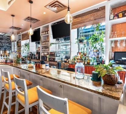 Stylish bar area on-site w/ polished counters & inviting seating for evening drinks