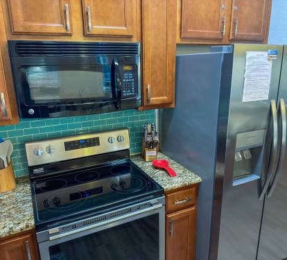The gourmet kitchen combines coastal charm with ample prep space for preparing meals and entertaining with ease.