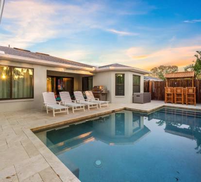 A stunning private pool area. Featuring a sparkling pool, comfortable sun loungers, and lush tropical landscaping, this outdoor oasis is a feast for the senses.