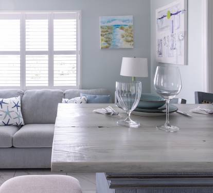 The kitchen island is set for two, with water glasses, wine glasses, plates, bowls, and silverware ready to go. A comfortable spot for breakfast, takeout, or sharing a bottle of wine at the end of the day.