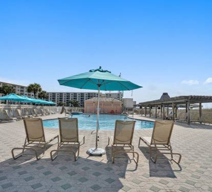 Shaded poolside pavilion offering seating for relaxing breaks.