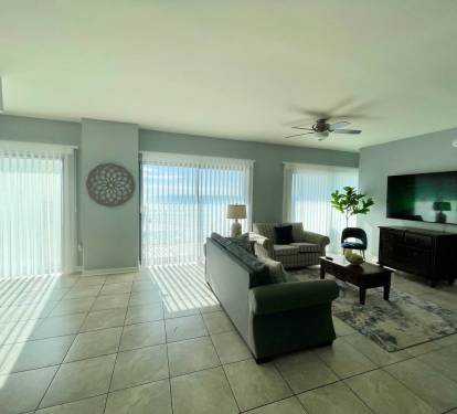 Living room with Smart blinds and  75" TV 