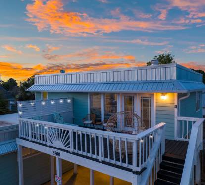 Right outside the game room, you'll find the front balcony, complete with patio seating, egg chair, and lounge chairs.